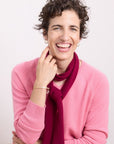 Cashmere Ruby Red Skinny Scarf elegant ruby red 100% cashmere skinny scarf styled with a soft pink knit for timeless everyday sophistication